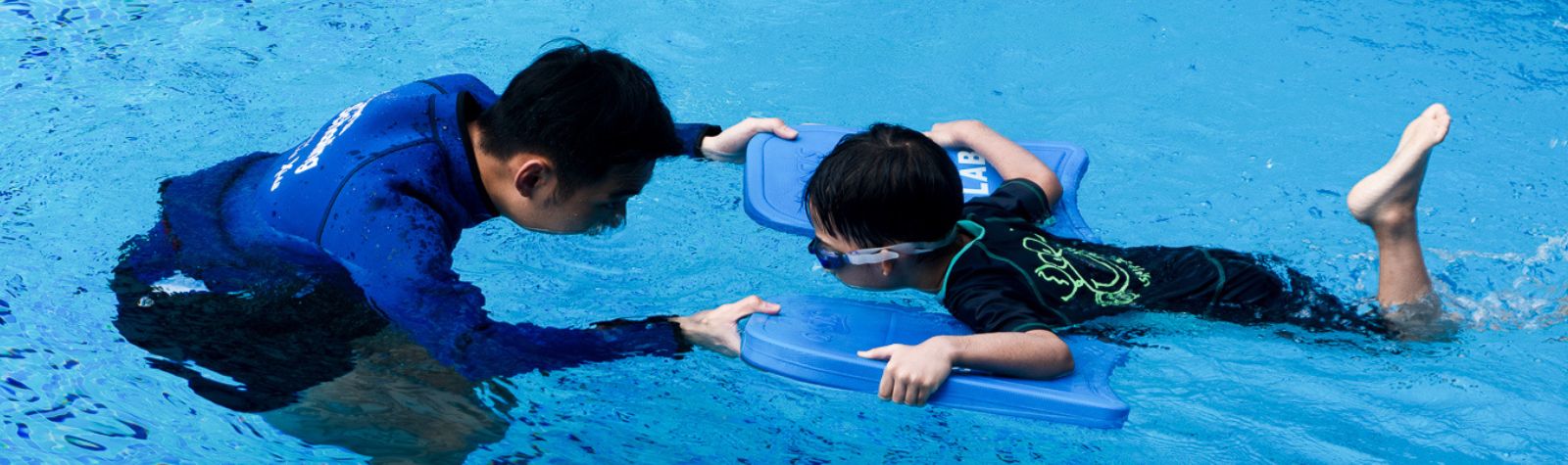 A Coach Teaching Bubble Blowing at The Swim Lab