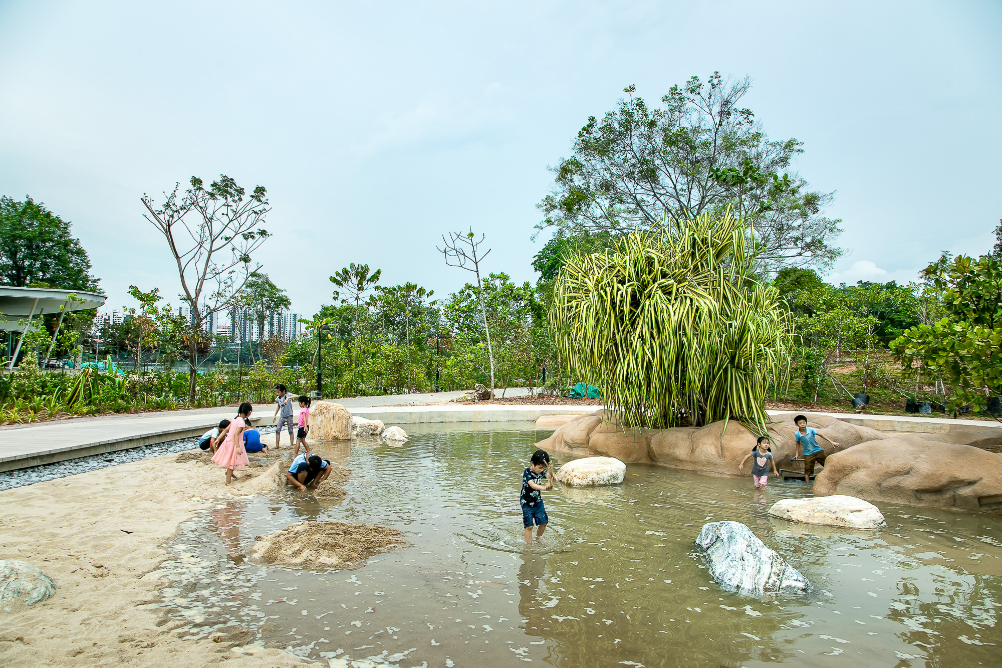 Children gleefully splashing in a DIY pond pool, enjoying a simple yet delightful water play experience.