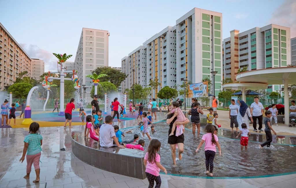 Water play area with a water curtain and oversized board game pieces, complemented by vending machines for drinks and ice cream.